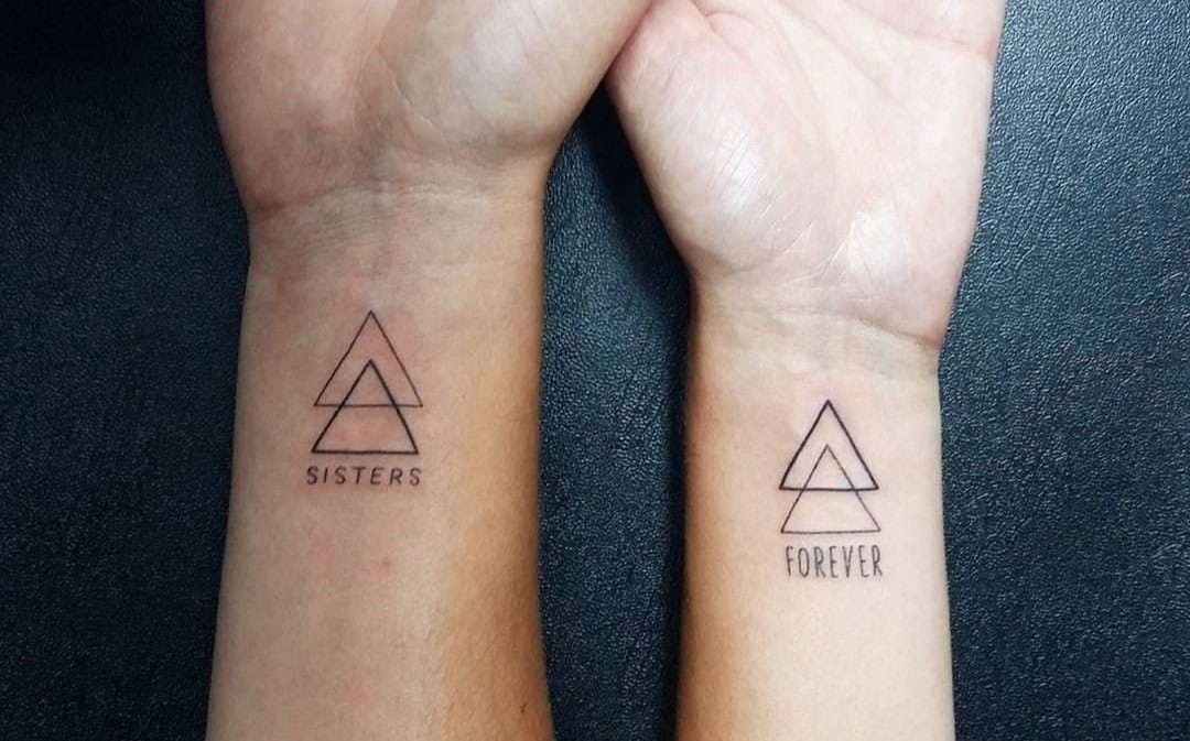 Matching tattoos for sisters: A symbol of unbreakable bonds and shared memories. 