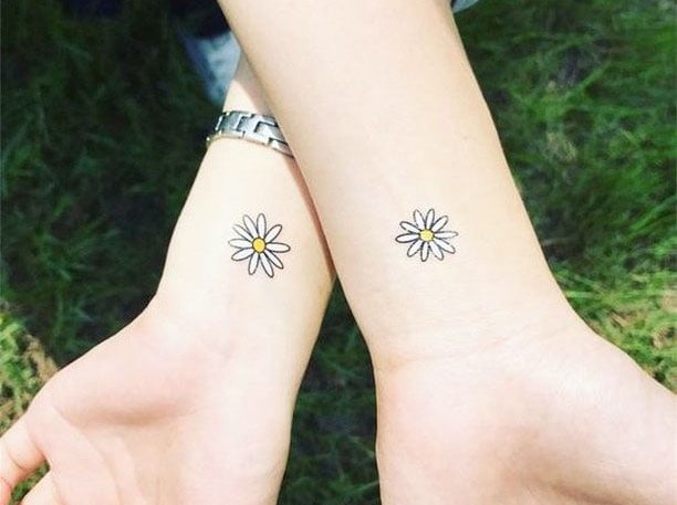 Express sisterly bond with matching tattoos - eternal connection.